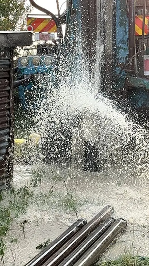 Water bursting out of the new borehole at Keyo Village