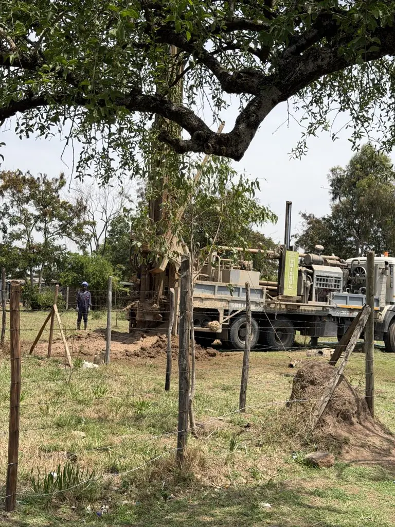Deep Core Wells rig drilling under a tree at Urudi, Kisumu County